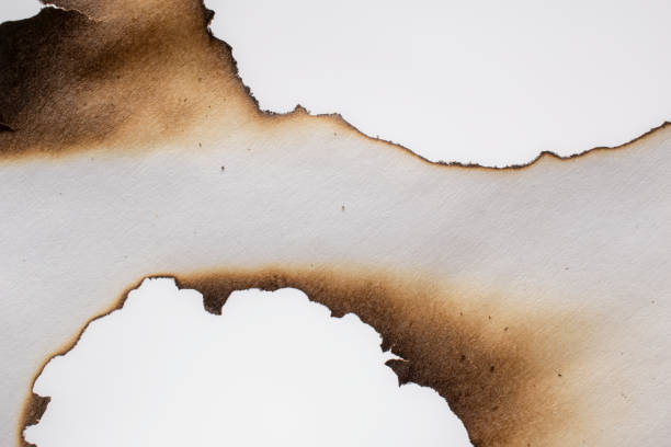 istock burning paper, glowing edge of paper on a white  background 1492108288