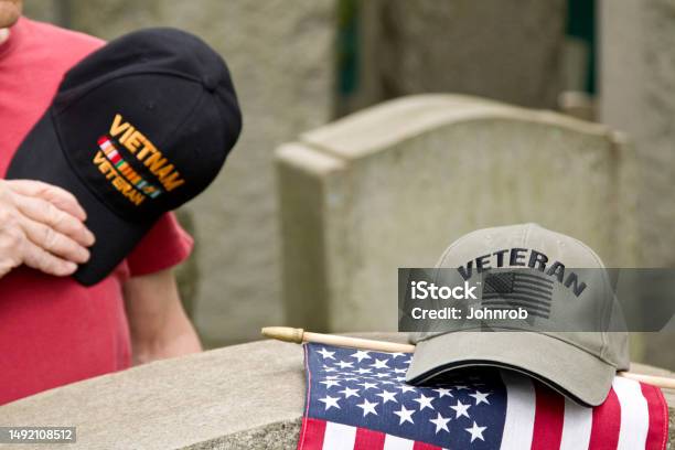 Vietnam Veteran Hat Over Heart Saluting Deceased Solider Stock Photo - Download Image Now