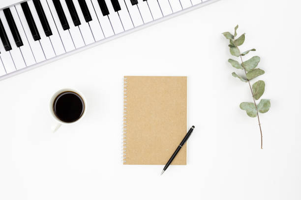 istock Music background with piano, notebook and coffee cup, top view. 1492108695