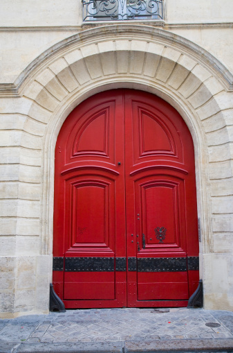red coach door on a street in the Ile St Louis in Paris, France