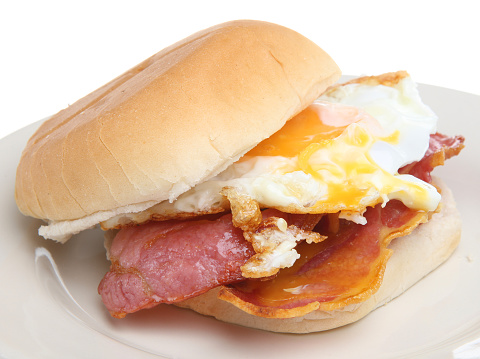 Crispy bacon and fried egg in a soft white roll