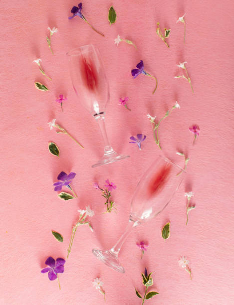 istock Creative pattern made of colorful flowers and two glasses on pastel pink background. Minimal style. Flat lay. 1492112355