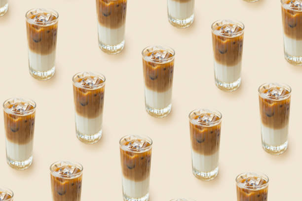 istock Pattern made from iced latte coffee in glass on beige background. Summer fresh coffe drink 1492129969