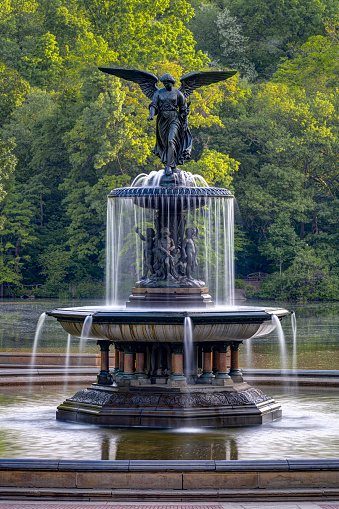 Manhattan, New York, USA - May 12, 2023:    Bethesda Fountain (Angel of the Waters Sculpture), Bethesda Terrace, Central Park.  This neoclassical sculpture, also known as Angel of the Waters, features an eight-foot bronze angel who stands above four small cherubim representing health, purity, temperance, and peace.