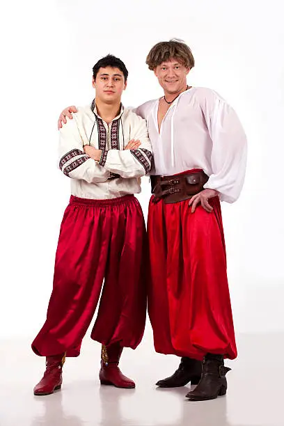 Two cossacks in national ukrainian dress over wite background