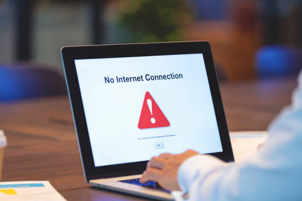 Businessman looking at an internet failure screen on a computer. Businessman looking at an internet failure screen on a computer. He is in an office poor signal stock pictures, royalty-free photos & images