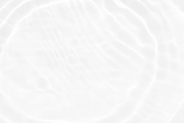 istock White water with ripples on the surface. Defocus blurred transparent white colored clear calm water surface texture with splashes and bubbles. Water waves with shining pattern texture background. 1492136796