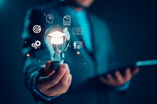 E-learning graduate certificate program concept. man holding lightbulb showing graduation hat, Internet education course degree, study knowledge to creative thinking idea and problem solving solution