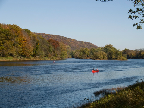 A canoe sails down the Delaware River, part of the Delaware National Recreation area between New Jersey and Pennsylvania.