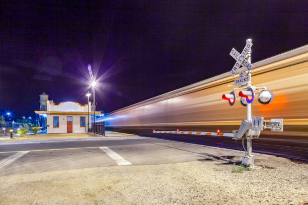 Railroad crossing by night with sign in kingman