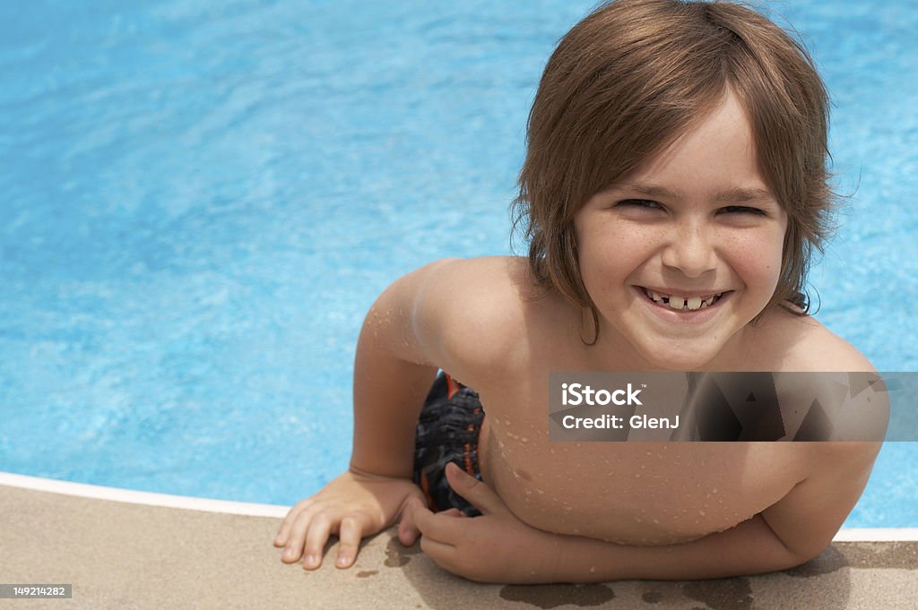 summer fun a boy smiling in swimming pool Boys Stock Photo