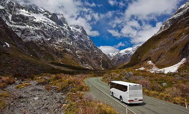 Bus trip in New Zealand A tourist bus in New Zealand on its way from Milford Sound to Te Anau. coach bus photos stock pictures, royalty-free photos & images