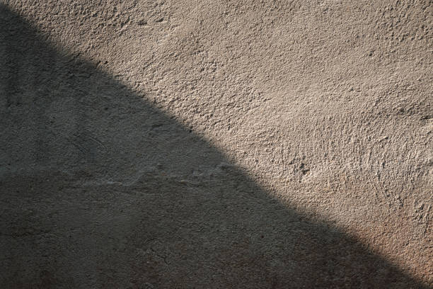 istock 45-Degree Lighting on Grey Cement and Sand Wall.  a sense of stability and harmony within challenging circumstances. A symbolic representation of resilience and the ability to maintain composure amidst adversity. 1492152737