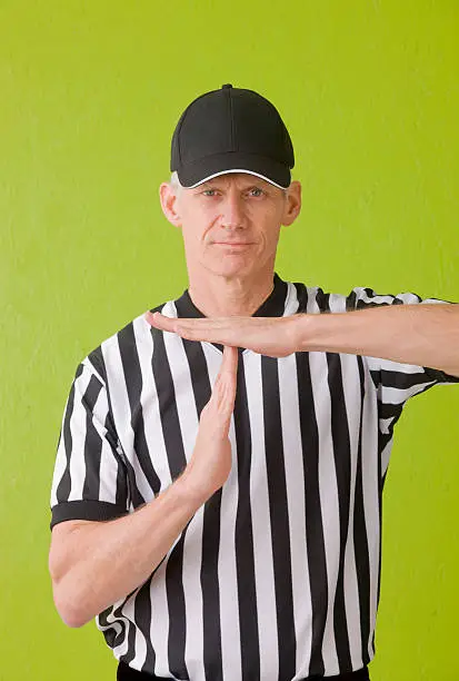 American football referee signaling a time out