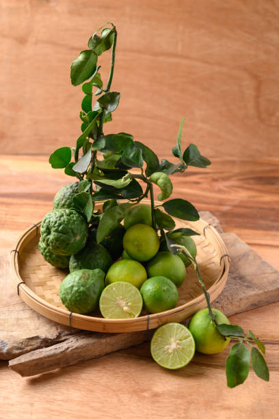 istock Kaffir lime and lime fruit on wooden background 1492158210