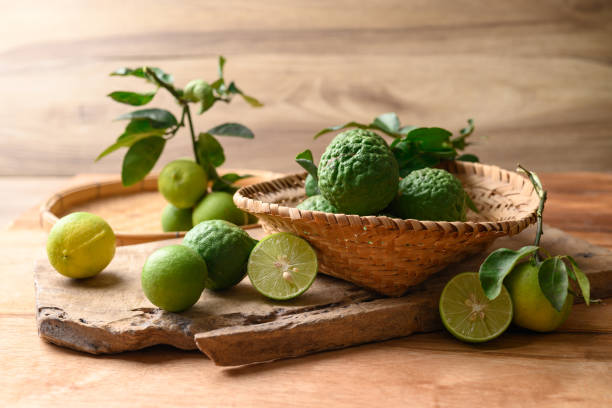 istock Kaffir lime and lime fruit on wooden background 1492158214