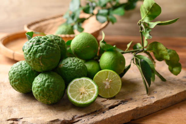 istock Kaffir lime and lime fruit on wooden background 1492158259