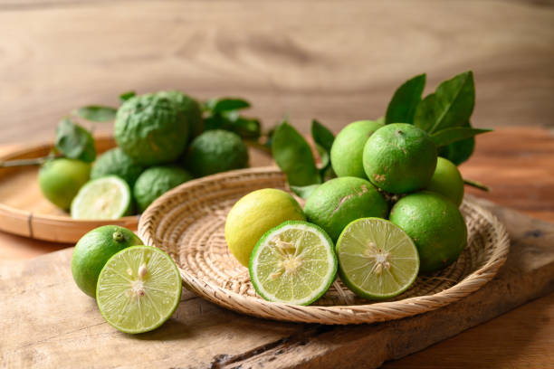 istock Kaffir lime and lime fruit on wooden background 1492158263
