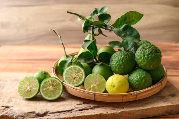 istock Kaffir lime and lime fruit on wooden background 1492158289
