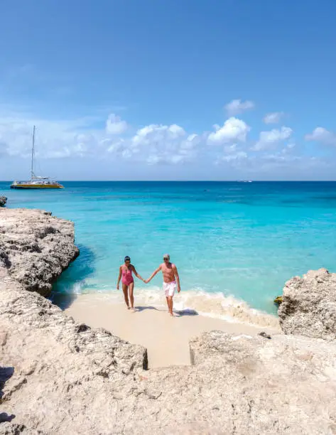 Tres Trapi Steps Triple Steps Beach, Aruba, Popular beach among locals and tourists for diving and snorkeling, couple man and woman in a crystal clear ocean in the Caribbean