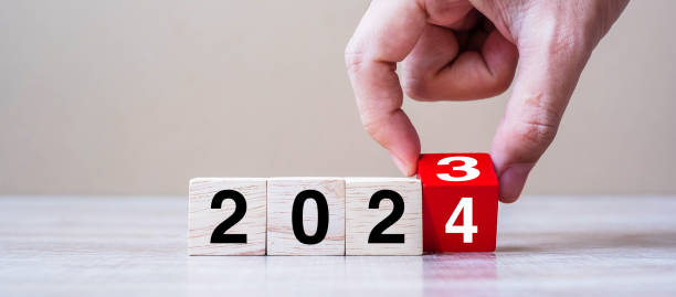 istock hand flipping block 2023 to 2024 text on table. Resolution, strategy, plan, goal, motivation, reboot, business and New Year holiday concepts 1492161868