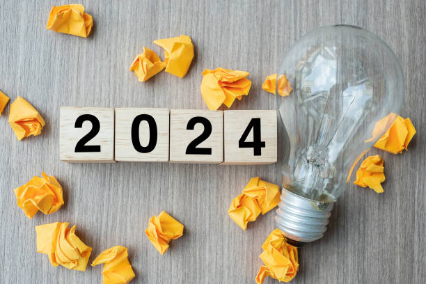 istock 2024 text wood cube blocks and crumbled paper with lightbulb on wooden table background. New Year New Ideas, Creative, Innovation, Imagination, inspiration, Resolution, Strategy and goal concept 1492161872