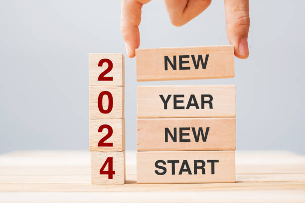 istock hand holding wooden block with text 2024 NEW YEAR NEW START on table background. Resolution, strategy, solution, business and holiday concepts 1492161892