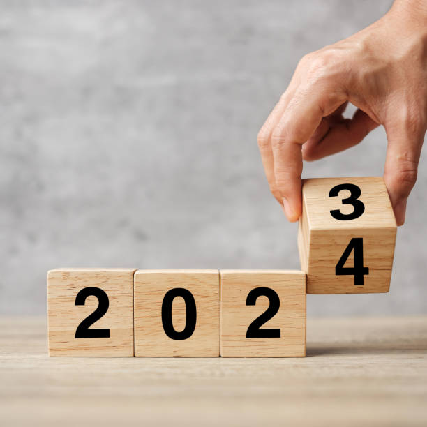 istock hand flipping block 2023 to 2024 text on table. Resolution, strategy, plan, goal, motivation, reboot, business and New Year holiday concepts 1492161908