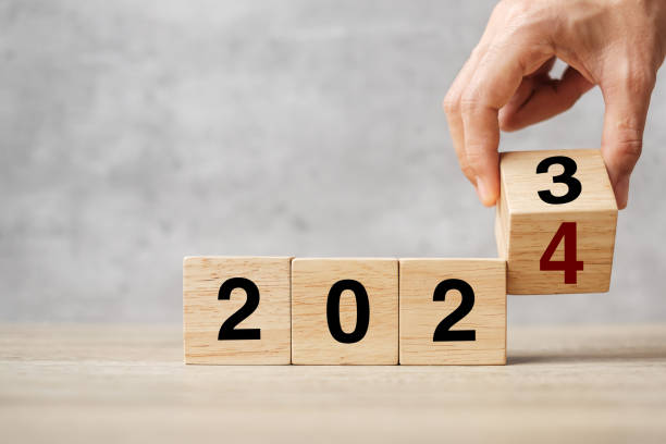 istock hand flipping block 2023 to 2024 text on table. Resolution, strategy, plan, goal, motivation, reboot, business and New Year holiday concepts 1492161910
