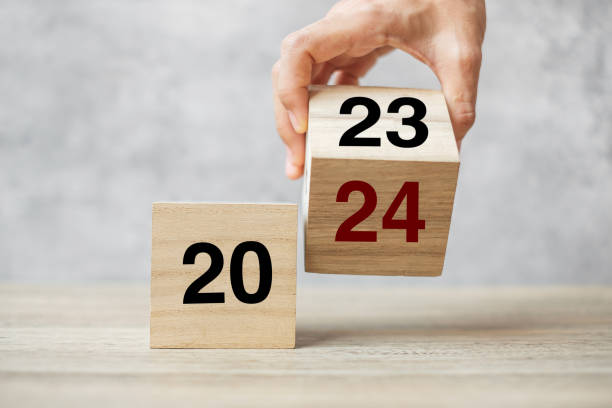 istock hand flipping block 2023 to 2024 text on table. Resolution, strategy, plan, goal, motivation, reboot, business and New Year holiday concepts 1492161913