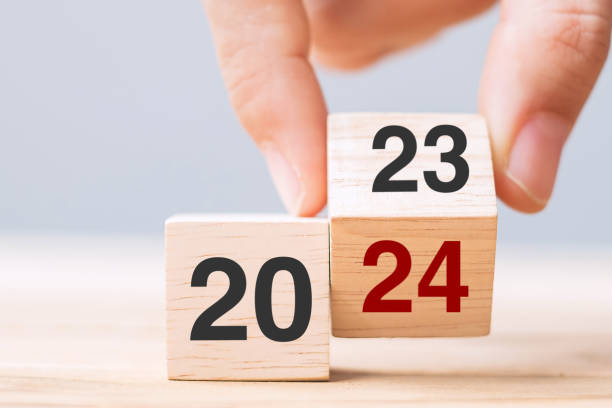istock hand flip cube block 2023 to 2024 text on table. Resolution, review, strategy, end year, goal, business and New Year holiday concepts 1492161923