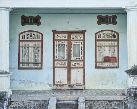 Heritage house in Penang. Vintage nanyang style houses. Abandoned old houses with chinese traditional wood curving doors.