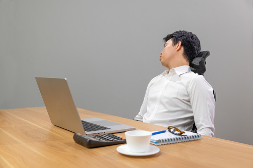 Man with narcolepsy is fall asleep on office desk.
Narcolepsy is a sleep disorder that makes people very drowsy during the day.