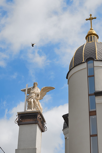 Rivne, Ukraine, May 5, 2022: Dome of the Church, sculpture of an angel and a dove above it, Ukrainian Greek Catholic Church of St. Nicholas
