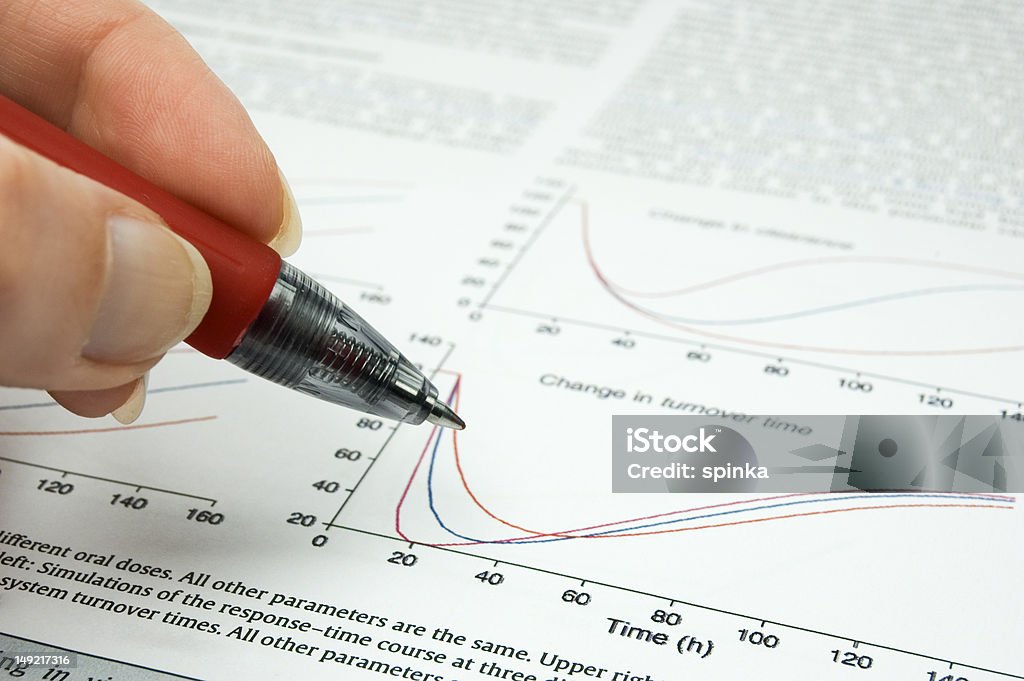 Science publication female hand holding hand over scientific article Science Stock Photo