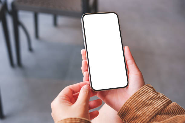 istock Mockup image of a woman holding mobile phone with blank desktop screen 1492180093