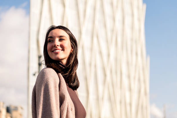 istock smiling young woman taking a walk enjoying city 1492181941