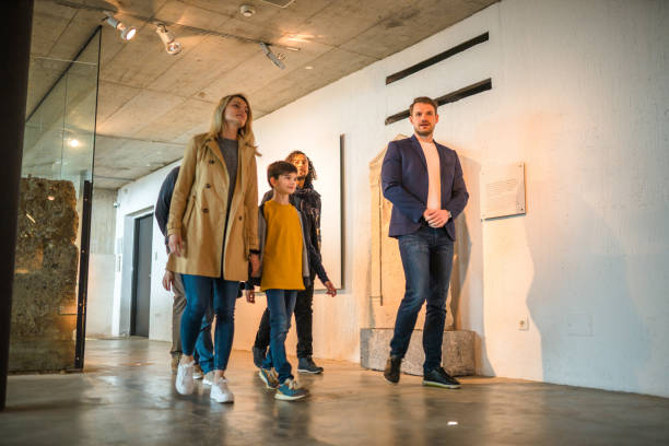 istock Mid Adult Brown-haired Museum Guide With Visitors 1492185088