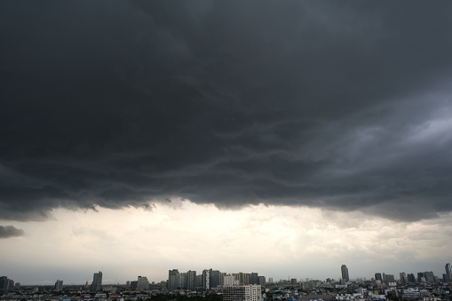 Climate of the rainy season dark sky covered with clouds and stormy windy rain. Urban landscape. Climate concept.