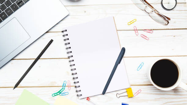 istock Modern workspace with coffee cup, keyboard and notebook on wooden background. Top view. Flat lay 1492196506