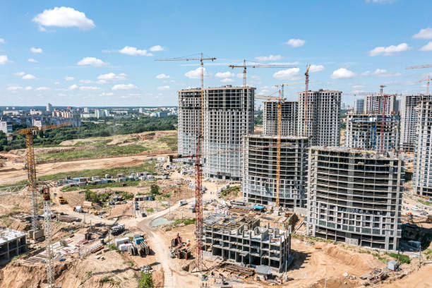 istock busy construction site with many cranes, construction equipment and materials. aerial view. 1492198655