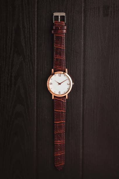istock Watch with brown leather strap on the wooden table 1492201827