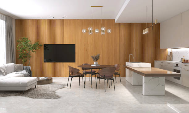 istock Living room with sofa on rug, dining table, island, beige kitchen counter, cabinet, cupboard on polished cement floor, wood panelling wall 1492202109