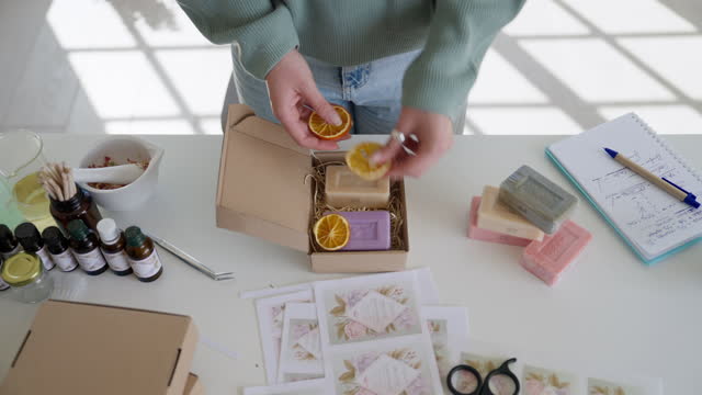 Unrecognisable woman packing her homemade soaps for delivery
