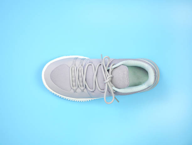 istock New Grey-light green sneakers isolated on blue background. 1492202490
