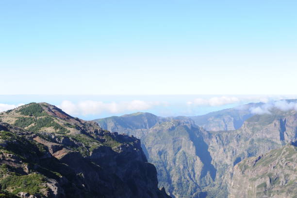 istock Clouds over mountains in Madeira island, Portugal 1492202590