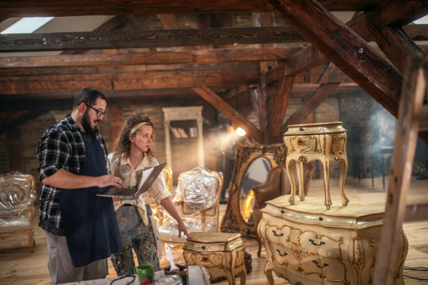istock restorers of old antique furniture work in the workshop 1492203479