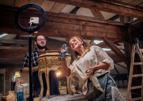 restorers of old antique furniture make an educational video live