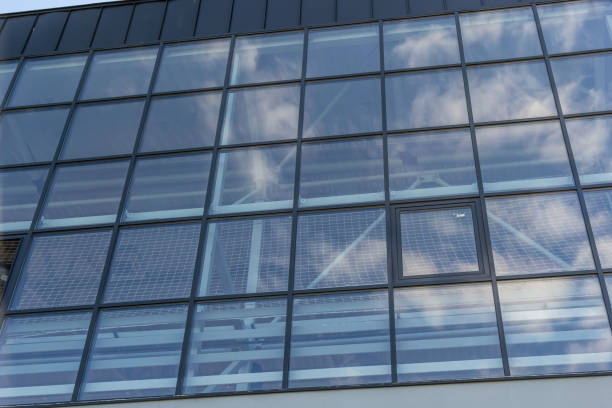 istock Bottom view of a modern skyscraper building with glass window against sky background for promotional content. Contemporary business centre with new perspective design 1492205786