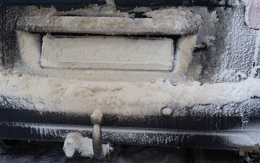 snow and mud covered car license plate. snow and mud covered the car license plate. Vehicle registration plate is not read.